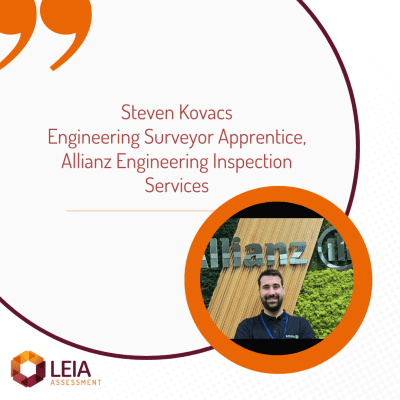 Image of an apprentice standing in front of the Allianz Engineering company sign.